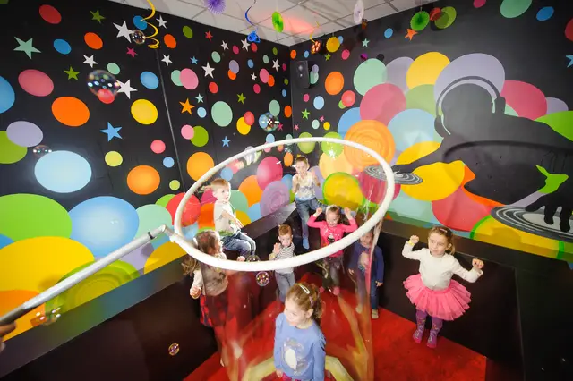 Children by a large bubble ring at a party