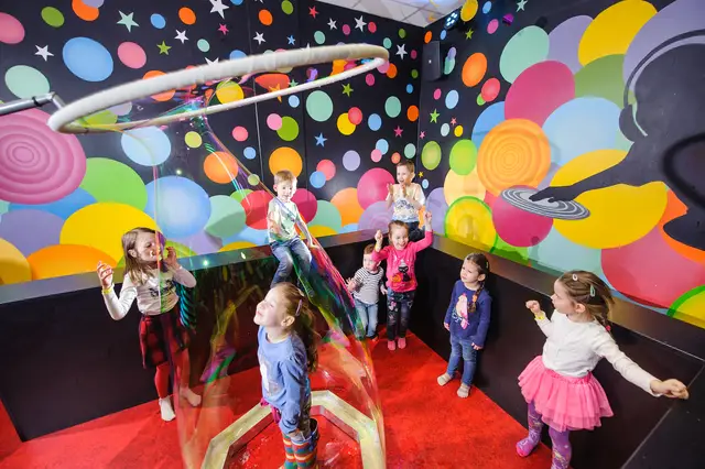 A group of children around a large bubble ring